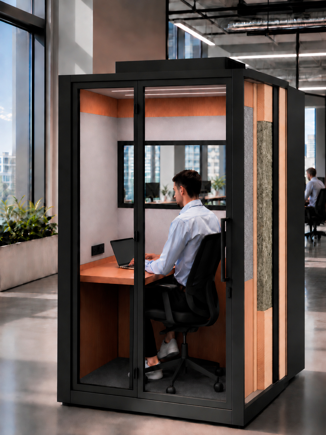 Cabina acústica Arquo instalada en una oficina, con el cerramiento de cinco capas visible en el lateral